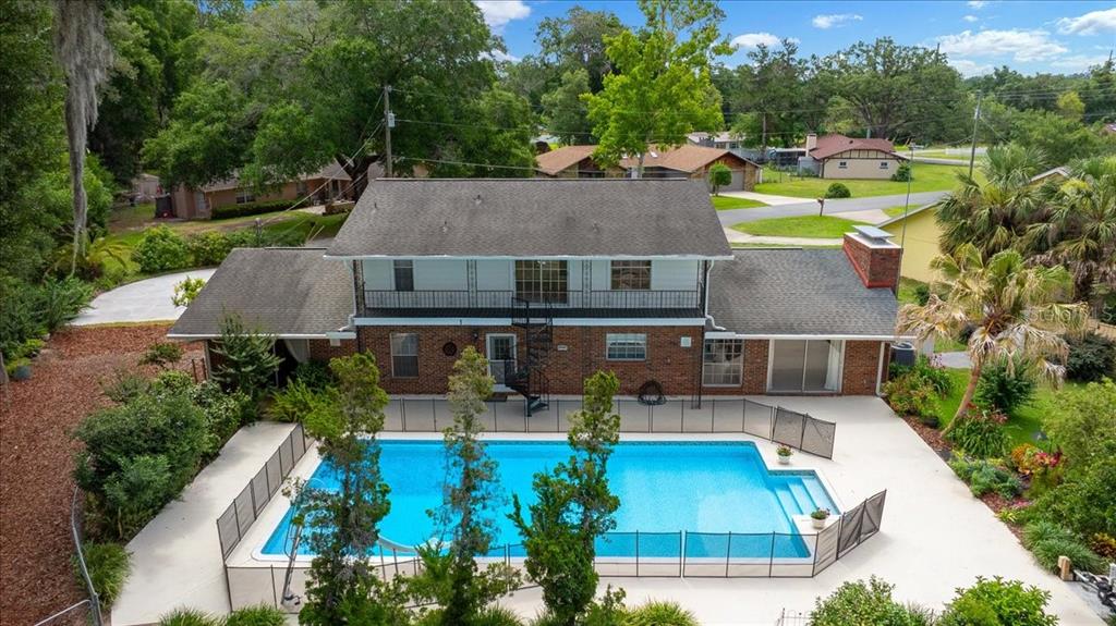 An aerial view of a two-story brick house with a pool and a spiral staircase — 2300 SE 38TH COURT, OCALA, FL