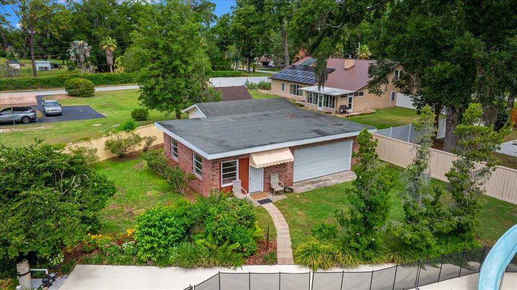 An aerial view of a brick house with a flat roof and a detached garage — 2300 SE 38TH COURT, OCALA, FL