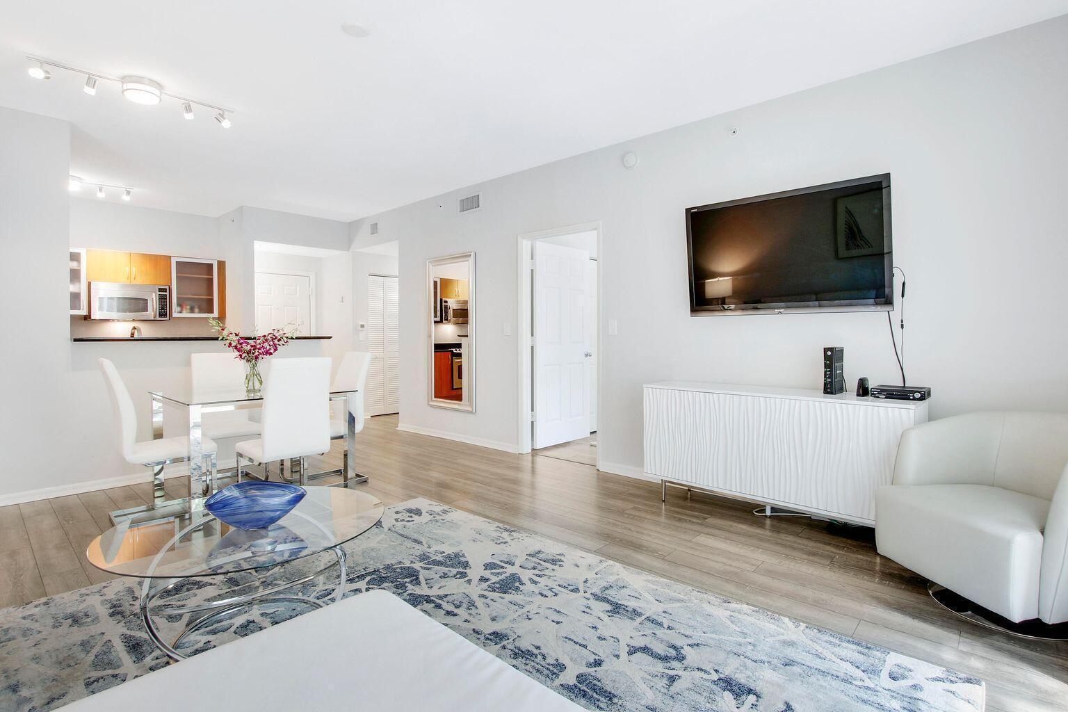 A living room and dining area with light wood floors, white furniture, and a rug — 802 W Windward Way # 206, Lantana FL 33462, LANTANA, FL