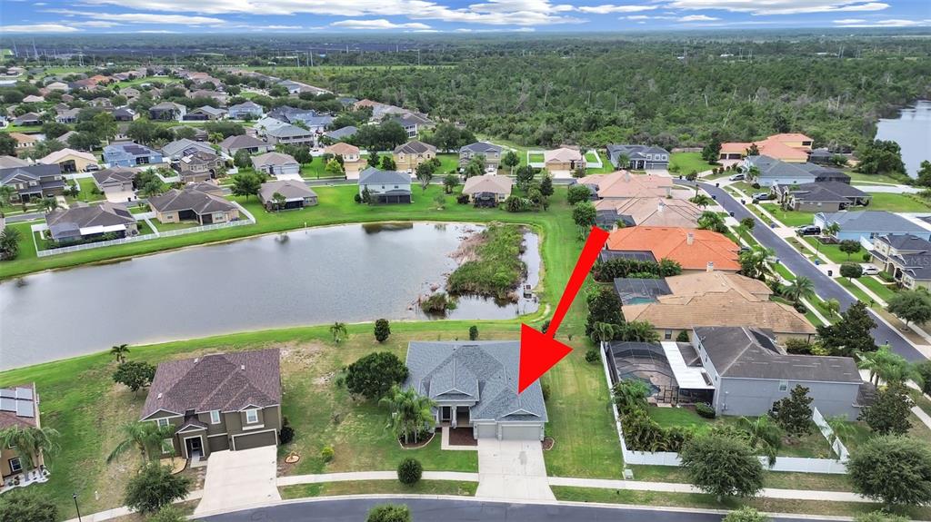 An aerial view shows a suburban house with a gray roof and a backyard pool — 2422 ALLEGHENY VALLEY STREET, RUSKIN, FL