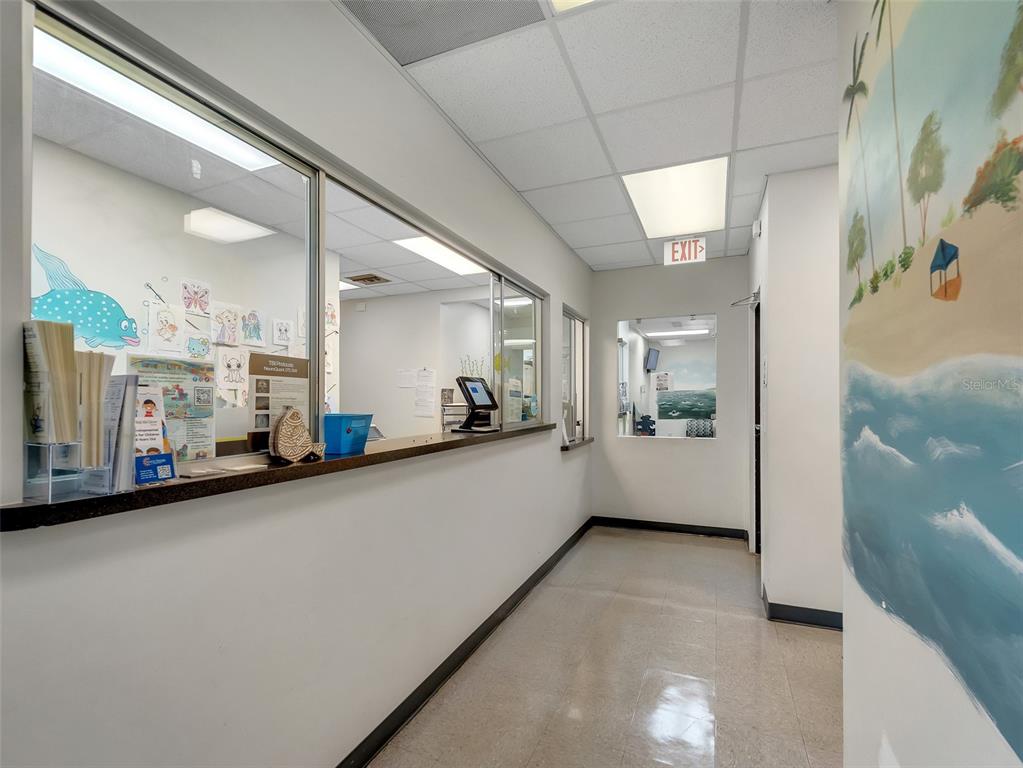 A reception area features a service window, tiled ceiling, and a painted beach mural — 11183 S ORANGE BLOSSOM TRAIL UNIT 103 / 102, ORLANDO, FL