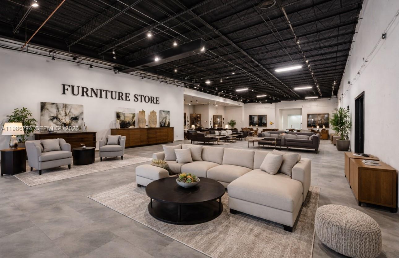 A spacious furniture store showroom features neutral-toned sofas, armchairs, and dark wood cabinets — 2950 N 28th Ter, Hollywood FL 33020, HOLLYWOOD, FL
