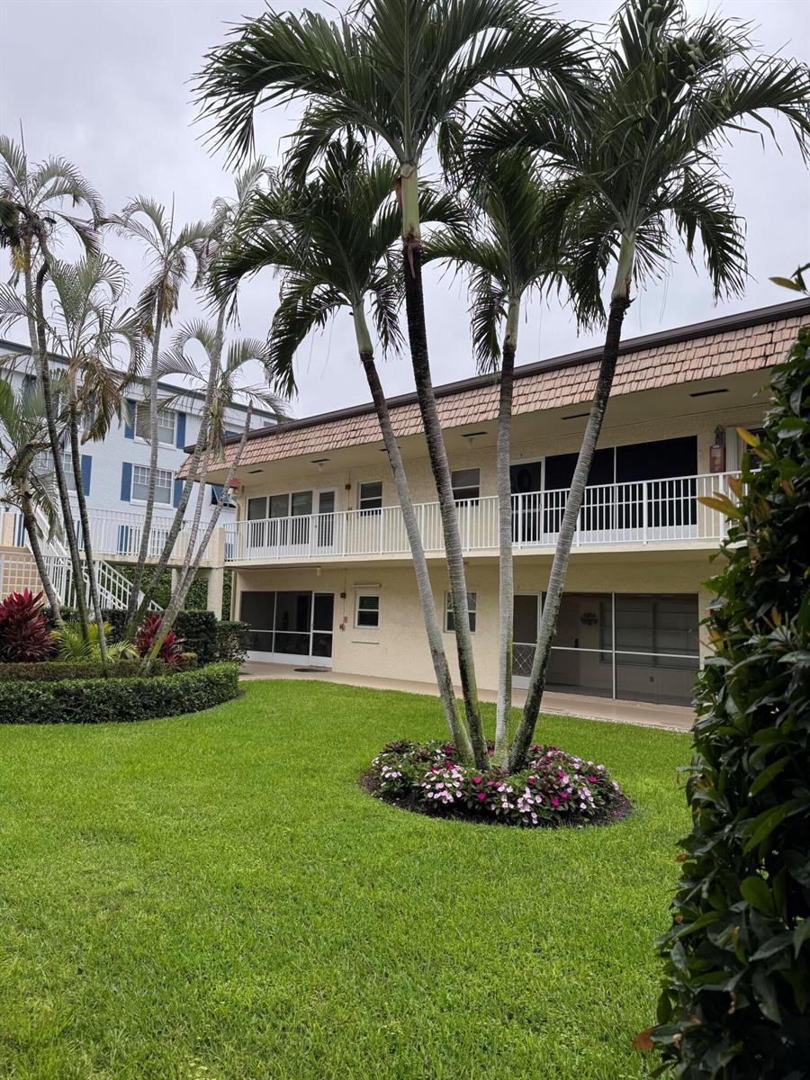A two-story apartment building exterior with palm trees and a landscaped lawn in the foreground — 632 Snug Harbor Drive # D6, Boynton Beach FL 33435, BOYNTON BEACH, FL