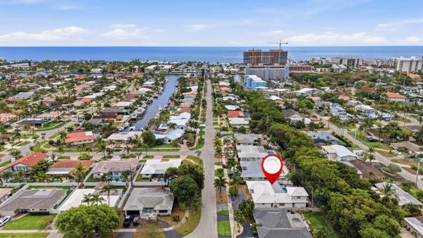An aerial view shows a residential neighborhood with a red location pin over a house — 1310 SE 14th Ct, Deerfield Beach FL 33441, DEERFIELD BEACH, FL