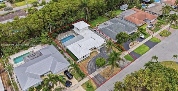 An aerial view shows a house with a white roof, swimming pool, and circular driveway — 1310 SE 14th Ct, Deerfield Beach FL 33441, DEERFIELD BEACH, FL