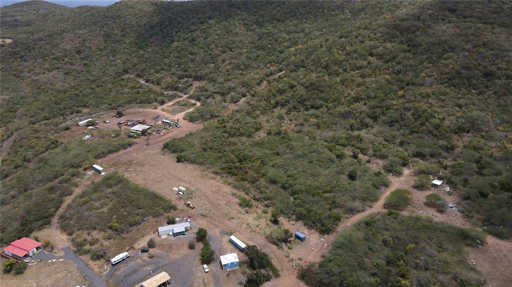 An aerial view shows a rural property with several small buildings and dirt access roads — PR 250 KM 2.5 BO FLAMENCO Y SAN ISIDRO, CULEBRA, PR