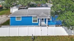 An aerial view of a blue single-story house with a white vinyl fence — 2963 BAHIA VISTA STREET, SARASOTA, FL