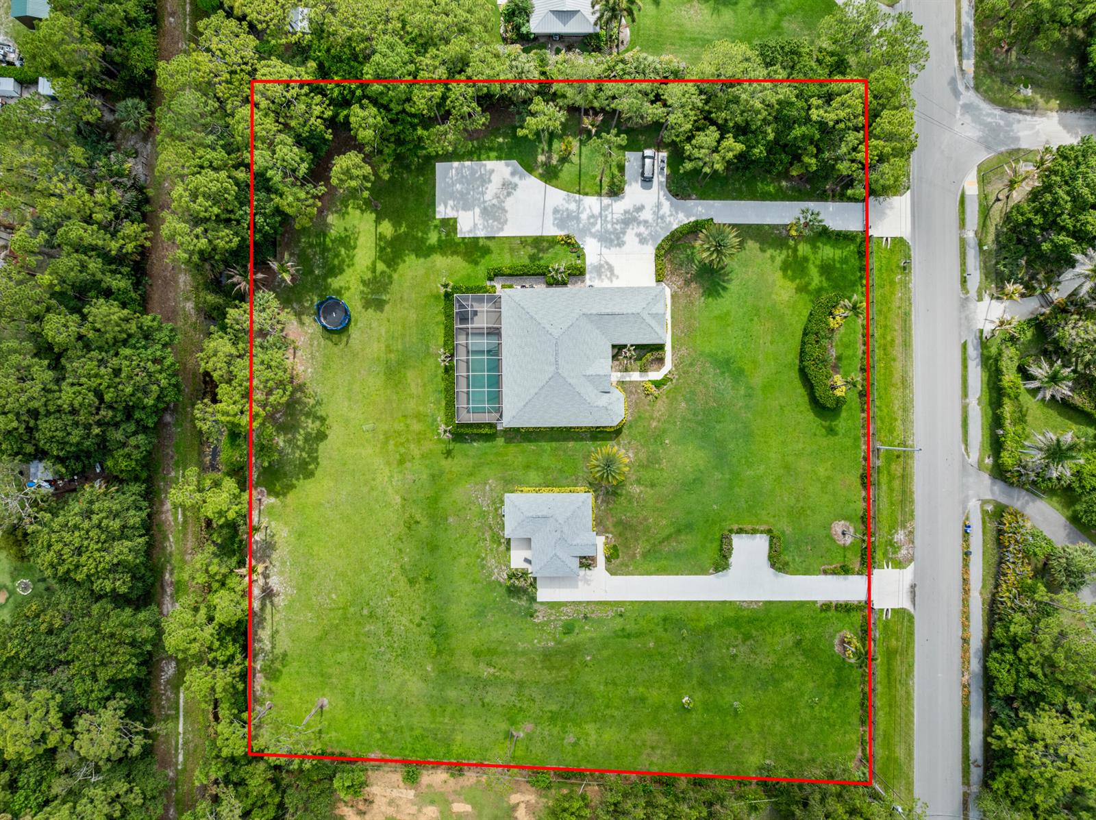 An aerial view shows a house with a pool and a detached garage on a large lot — 11354 Sandy Run, FL 33478, FL