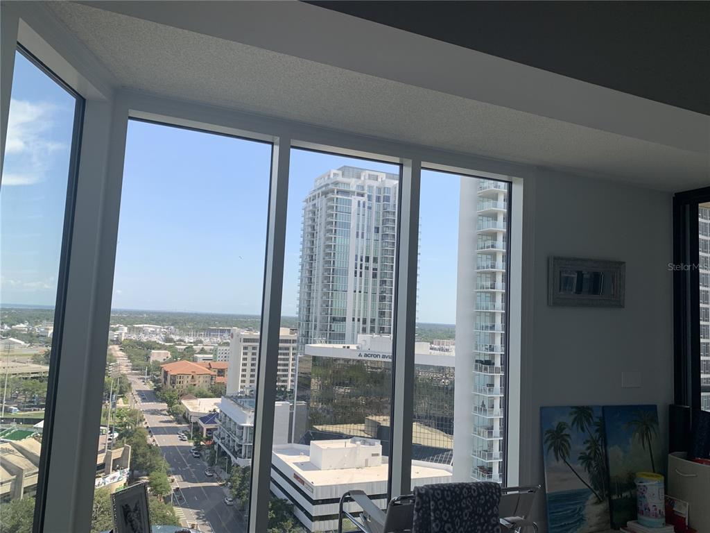 A view of a city street and high-rise buildings from a room with floor-to-ceiling windows — 1 BEACH DRIVE SE UNIT 1907, ST PETERSBURG, FL