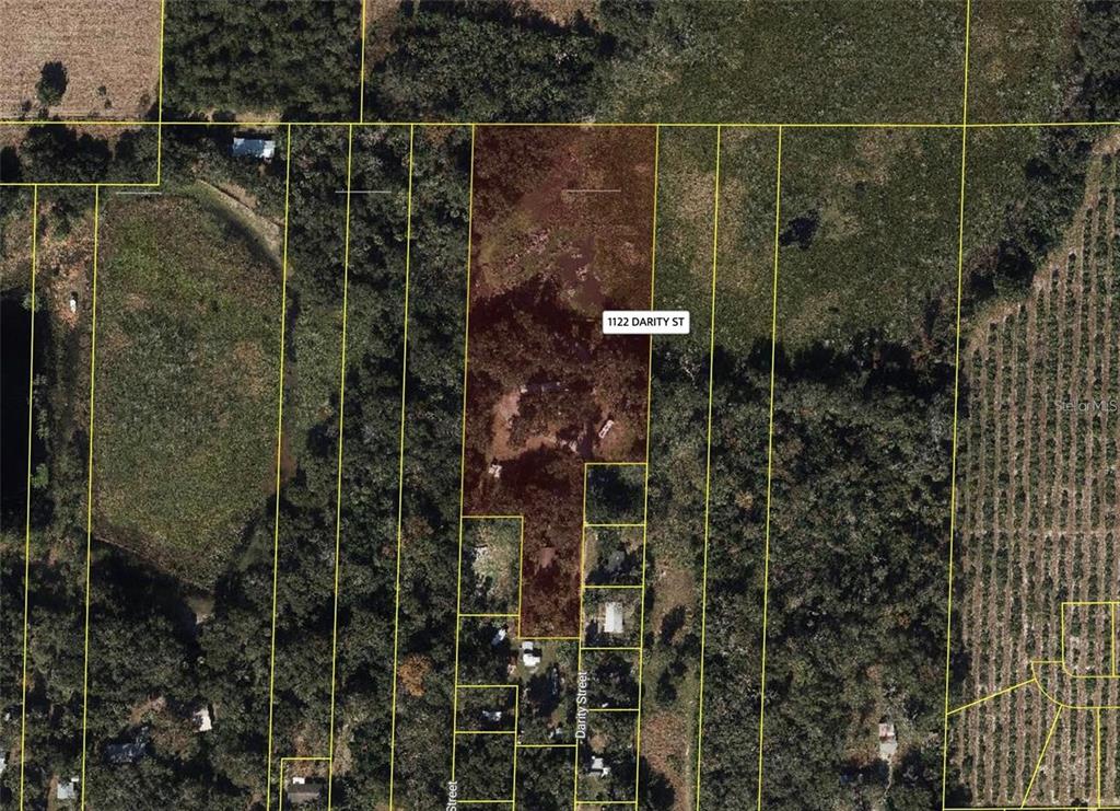 This is an aerial map showing a rectangular property parcel highlighted in brown — 1122 DARITY STREET, APOPKA, FL