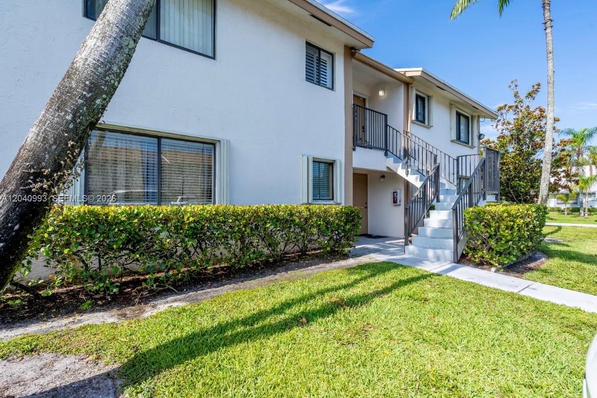 Exterior view of a two-story apartment building with stairs leading to the second floor — 232 NW 60th Ave # 232, Margate FL 33063, MARGATE, FL
