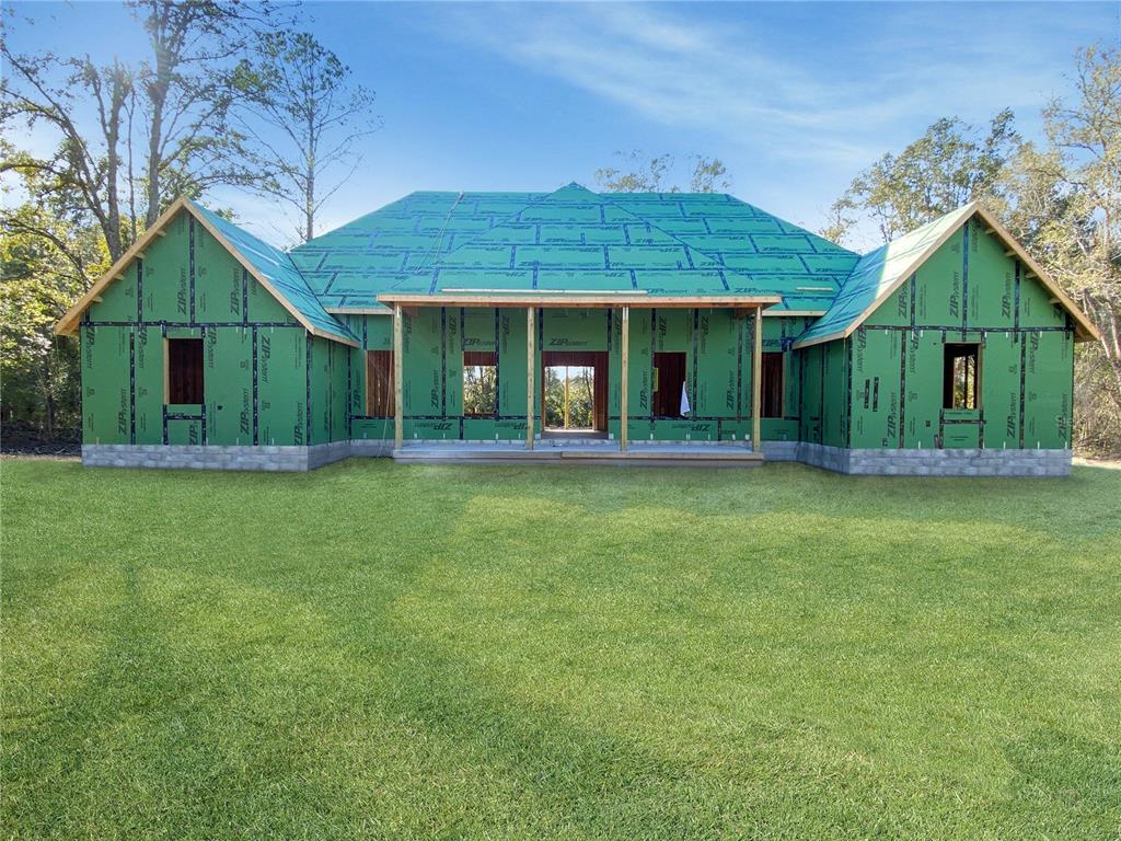 A newly constructed house with green ZIP System sheathing stands on a grassy lot — 5783 NE 51ST TERRACE, HIGH SPRINGS, FL