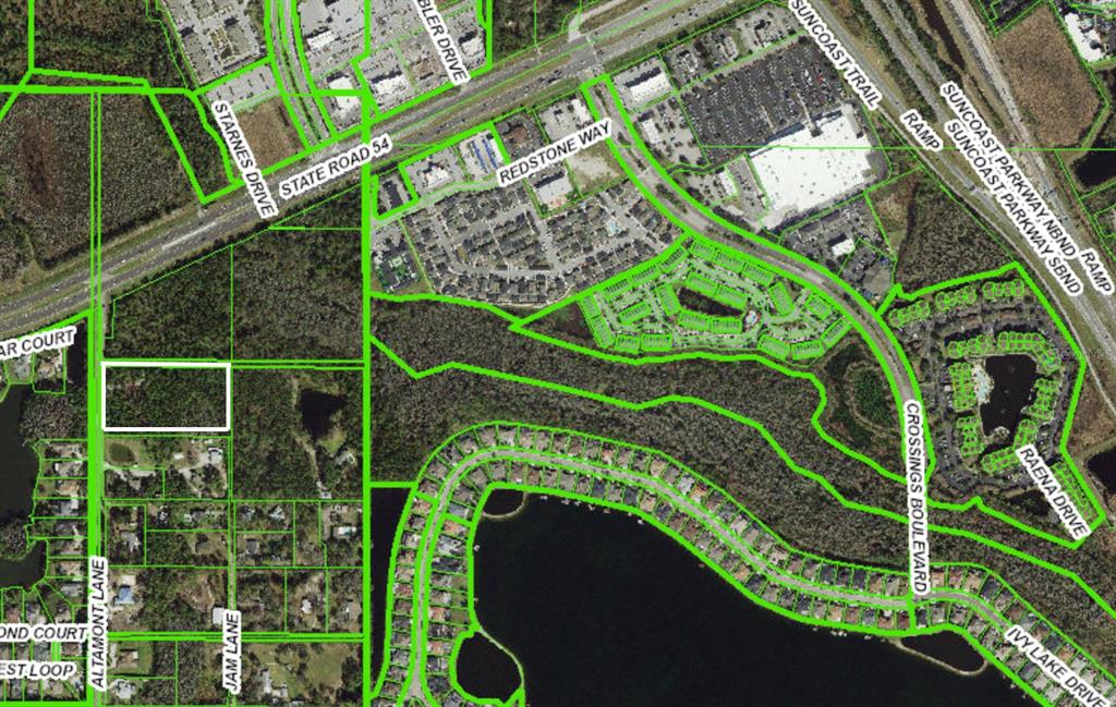 This is an aerial map showing a highlighted rectangular property lot surrounded by residential areas — 0 ALTAMONT LANE, ODESSA, FL