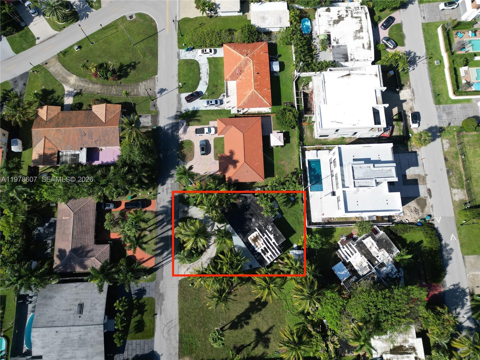 This aerial view shows a residential property with a flat roof and surrounding palm trees — 331 188th St, Sunny Isles Beach FL 33160, SUNNY ISLES BEACH, FL