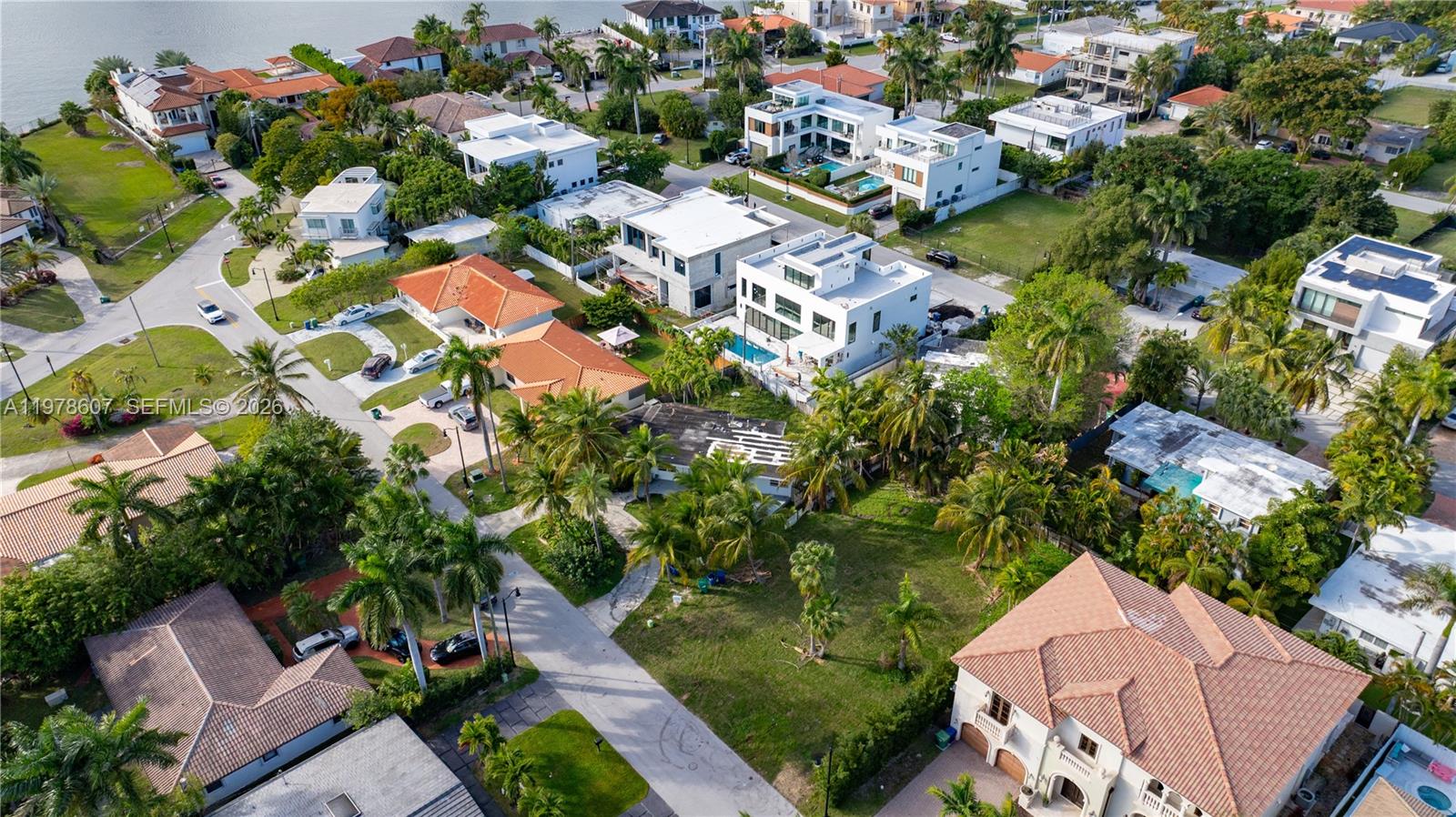 An aerial view shows several modern houses with swimming pools surrounded by lush tropical landscaping — 331 188th St, Sunny Isles Beach FL 33160, SUNNY ISLES BEACH, FL
