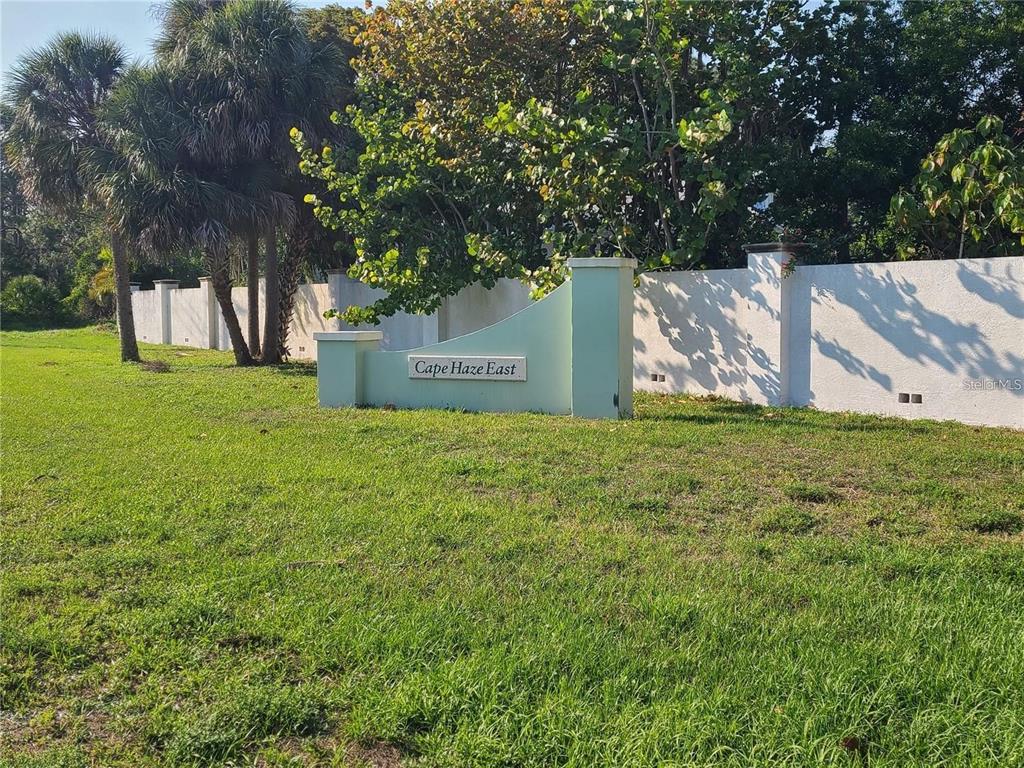 A light green monument sign for Cape Haze East stands on a grassy lawn — 70 COBIA DRIVE, PLACIDA, FL