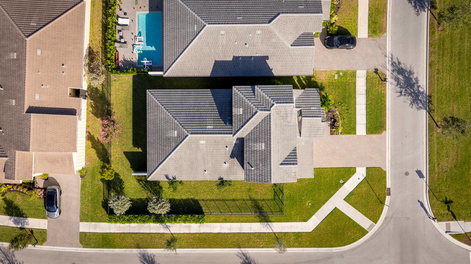 An aerial view shows two residential houses with tiled roofs, driveways, and a swimming pool — 19199 Rolling Acres Road, FL 33470, FL