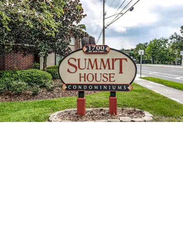 A sign for Summit House Condominiums stands in a grassy area near a road — 1700 SW 16TH COURT UNIT K24, GAINESVILLE, FL