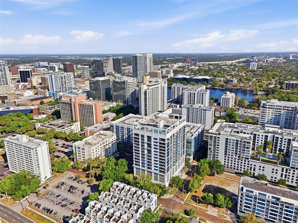 An aerial view of a dense urban cityscape featuring numerous high-rise buildings and a lake — 260 S OSCEOLA AVENUE UNIT 902, ORLANDO, FL
