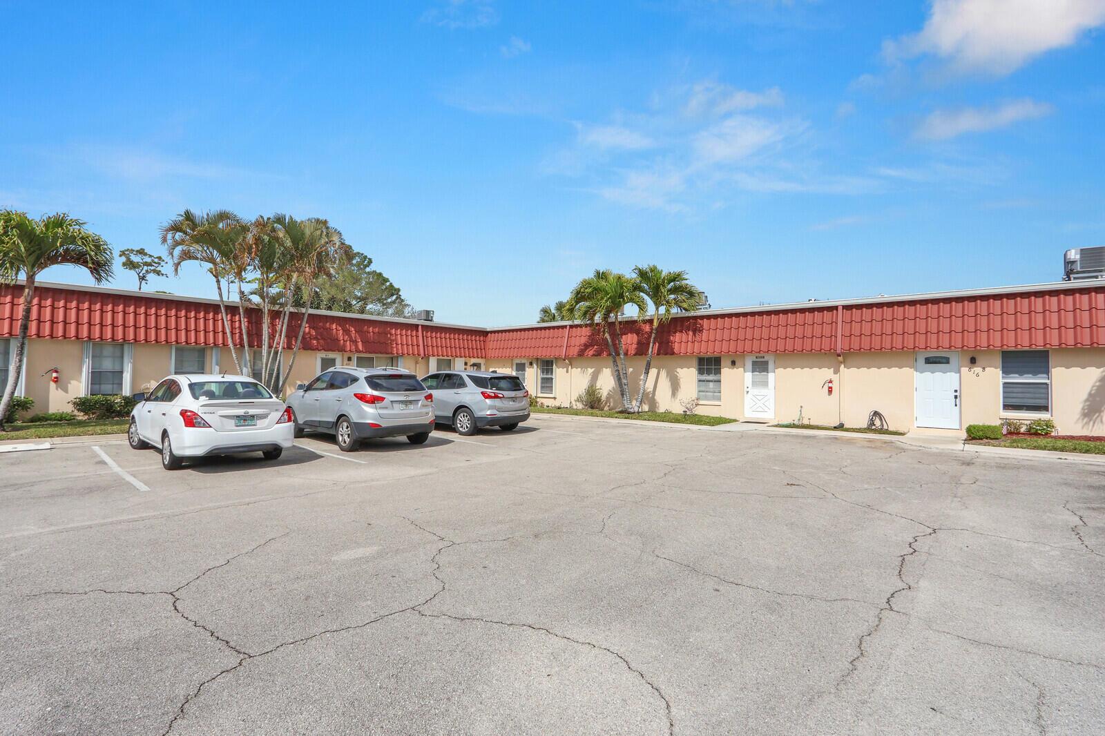 A single-story apartment building with a red tile roof and a paved parking lot — 615 Laconia Circle # A, Lake Worth FL 33467, LAKE WORTH, FL