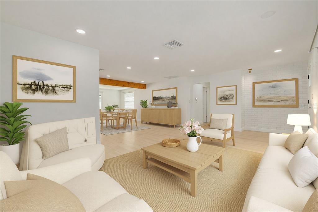 A bright, open-concept living and dining area with light wood floors and neutral furniture — 2631 OAKBROOK DRIVE, LARGO, FL
