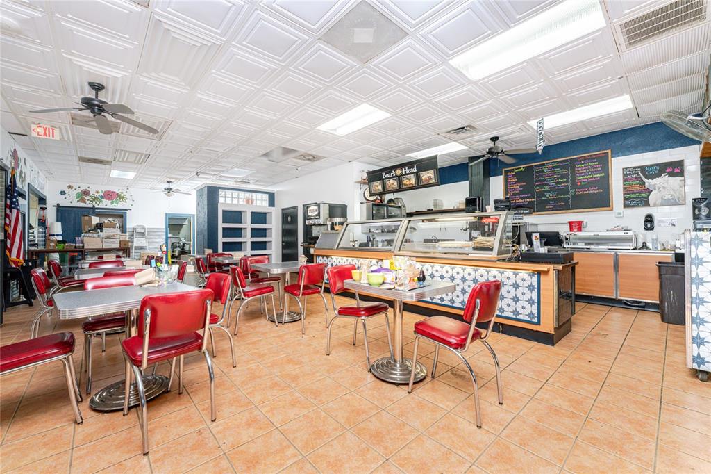 A commercial deli interior features red retro chairs, tiled floors, and a service counter — 23064 HARBORVIEW ROAD UNIT A and B and C, PORT CHARLOTTE, FL