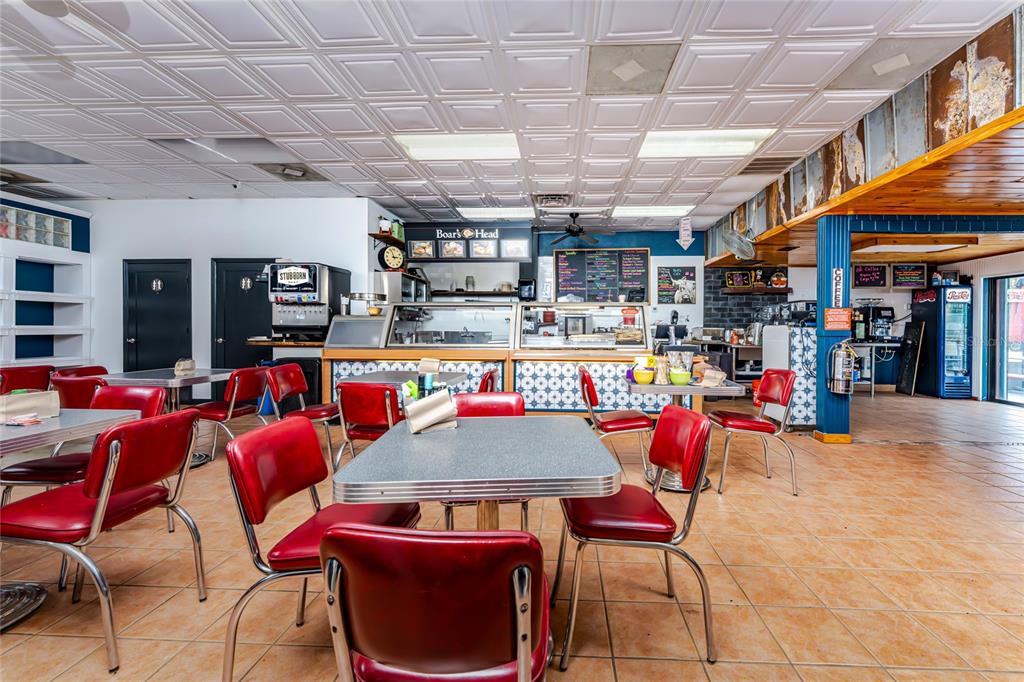 A restaurant interior features red vinyl chairs, metal tables, and a tiled drop ceiling — 23064 HARBORVIEW ROAD UNIT A and B and C, PORT CHARLOTTE, FL