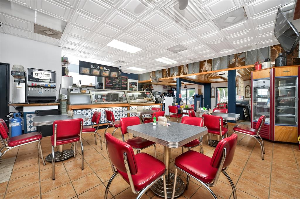 A diner interior features red vinyl chairs, square tables, and a patterned drop ceiling — 23064 HARBORVIEW ROAD UNIT A and B and C, PORT CHARLOTTE, FL