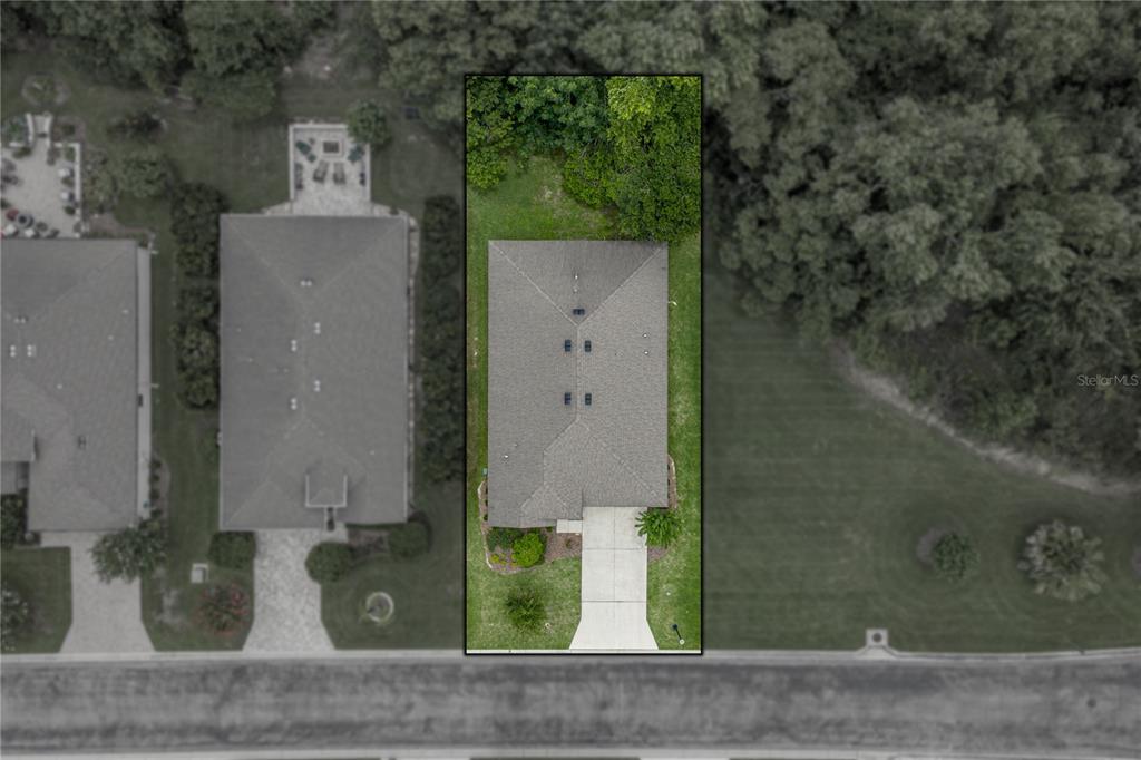This is an aerial view of a single-family home with a driveway and backyard — 12322 EASTPOINTE DRIVE, DADE CITY, FL