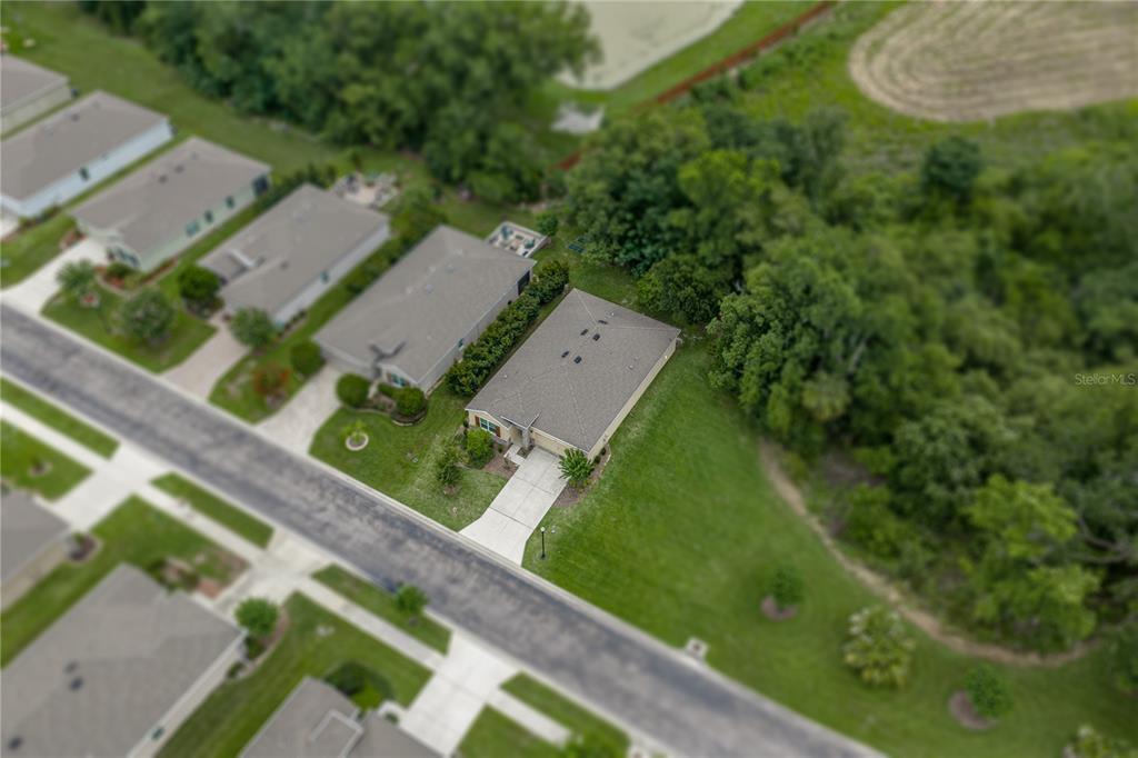 An aerial view shows a single-story house with a gray roof and driveway — 12322 EASTPOINTE DRIVE, DADE CITY, FL