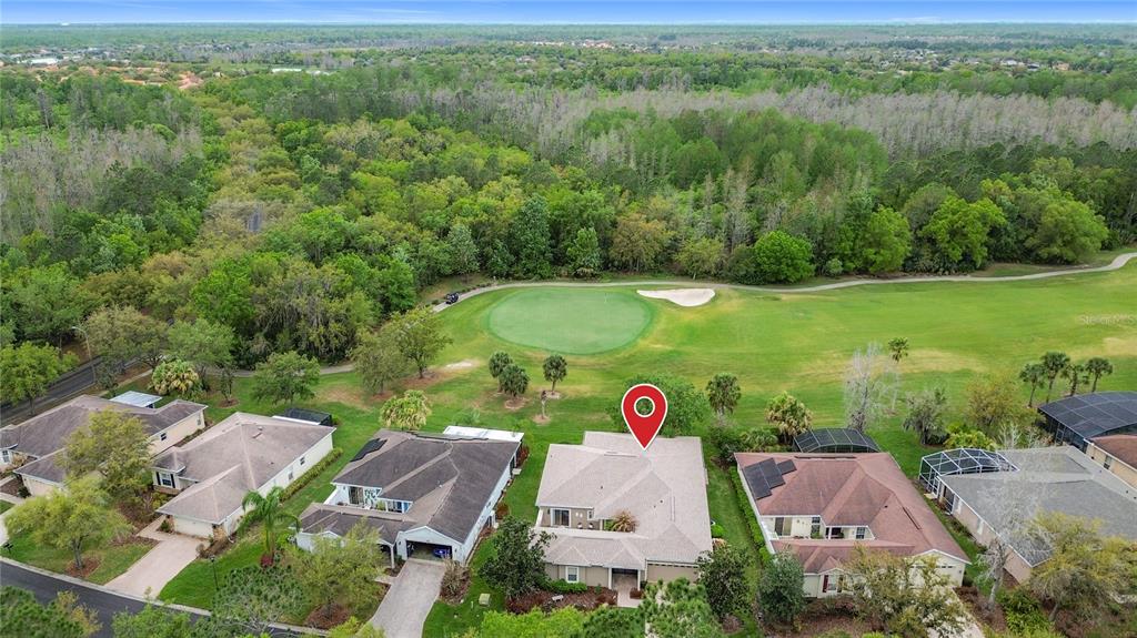 An aerial view shows a suburban house with a red location pin near a golf course — 352 HAMRICK DRIVE, KISSIMMEE, FL