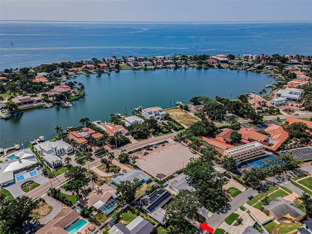 An aerial view shows a residential neighborhood situated along a bay and a small inlet — 861 RAFAEL BOULEVARD NE, ST PETERSBURG, FL