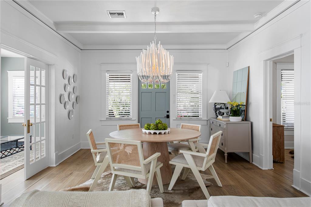 A dining room features a round wooden table, four cane chairs, and a white chandelier — 3407 W SAN PEDRO STREET, TAMPA, FL