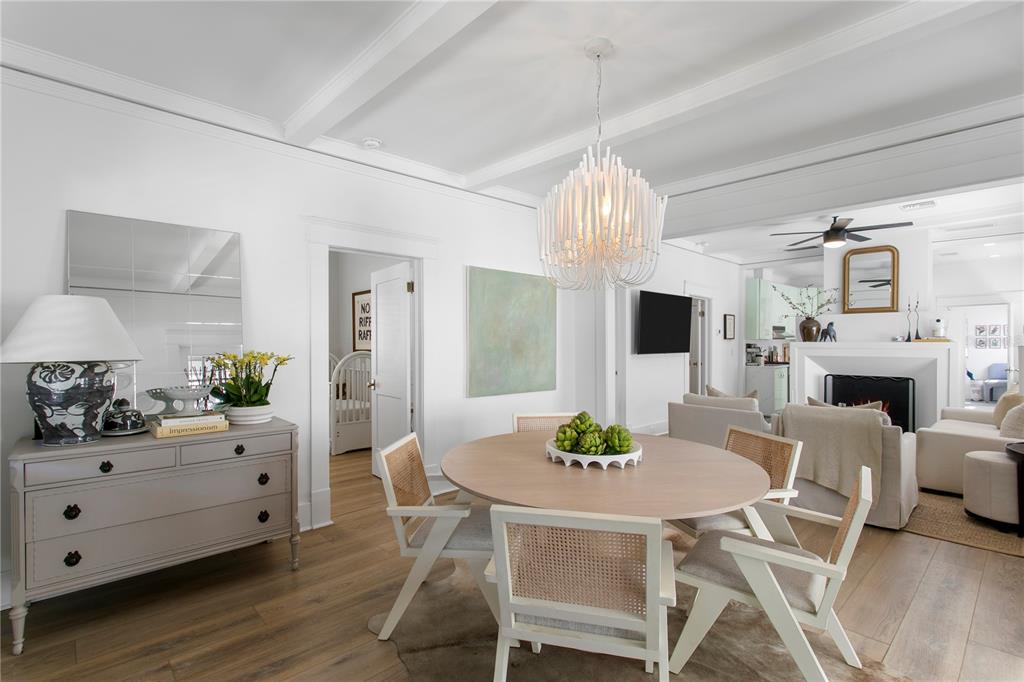 A dining area with a round table, cane chairs, and a white chandelier in a room — 3407 W SAN PEDRO STREET, TAMPA, FL