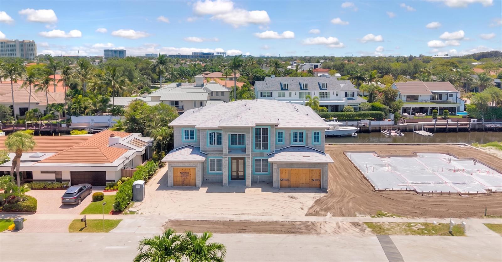 An aerial view of a two-story house under construction with a concrete foundation nearby — 748 NE Bay Isle Drive, Boca Raton FL 33487, BOCA RATON, FL