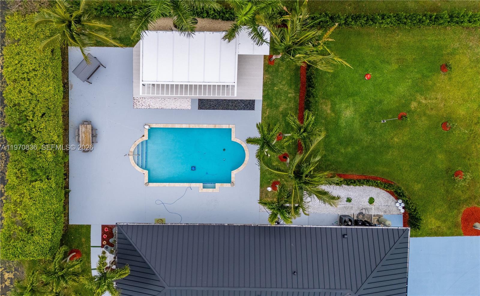 An aerial view shows a backyard with a swimming pool, patio, and covered structure — 2651 SW 141st Ter, Davie FL 33330, DAVIE, FL