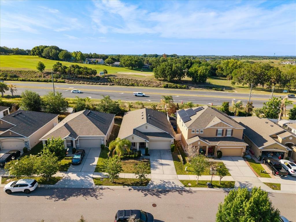 A single-story house with a beige exterior, a two-car garage, and a front lawn — 1269 WATER WILLOW DRIVE, GROVELAND, FL