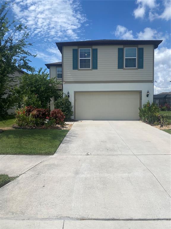 A two-story house with a beige stucco and siding exterior and a two-car garage — 9126 ROYAL RIVER CIRCLE, PARRISH, FL