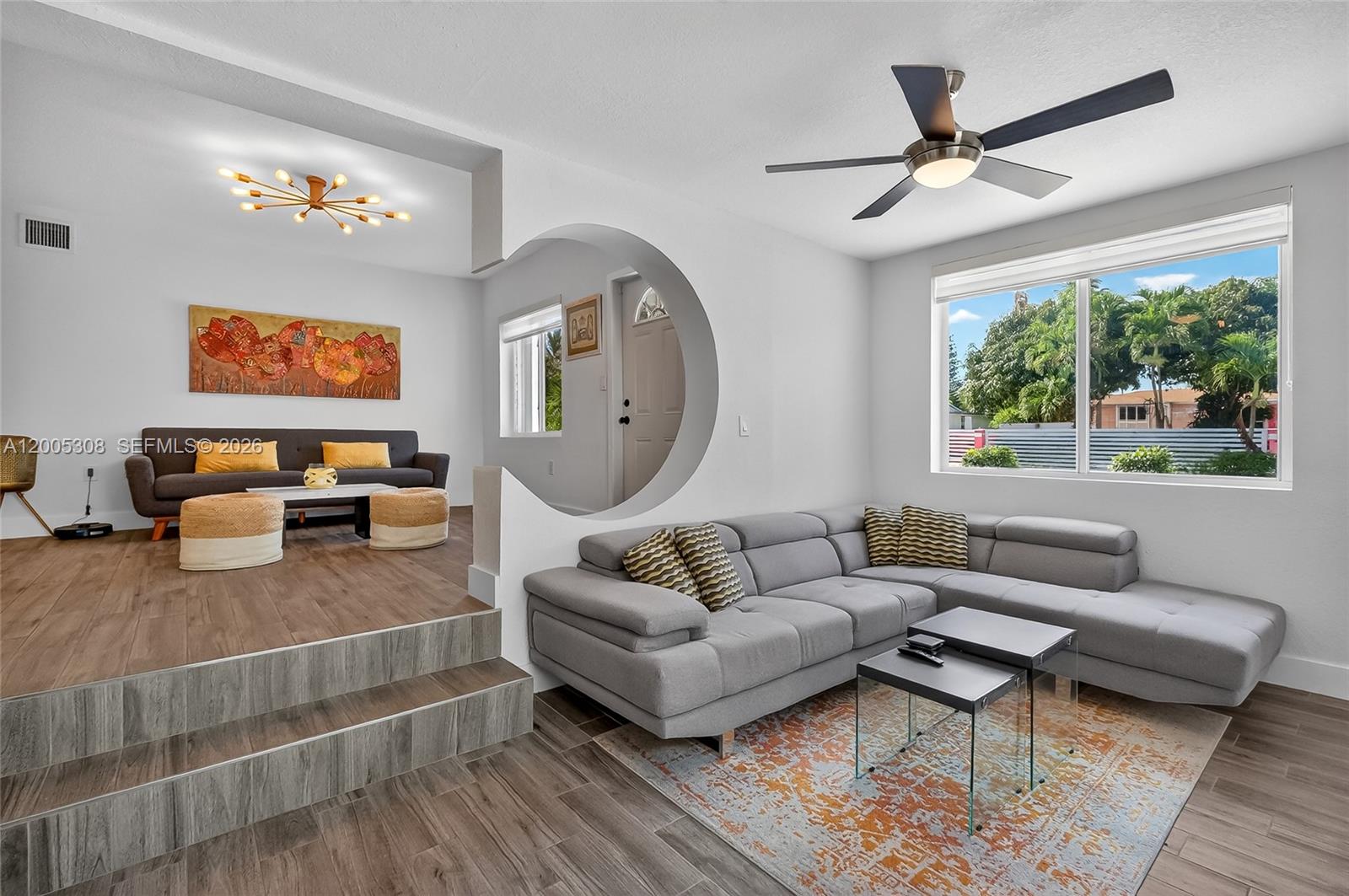 A modern kitchen features white cabinets, dark countertops, stainless steel appliances, and a breakfast bar — 541 NW 109th St, Miami FL 33168, MIAMI, FL