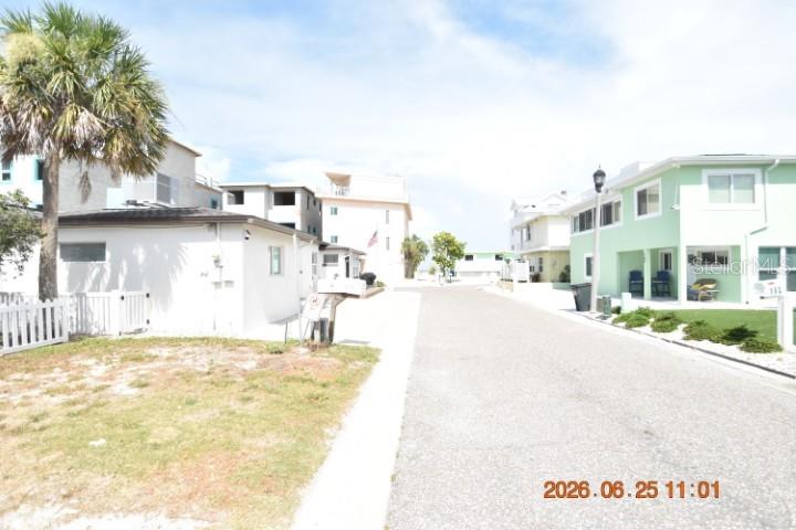 A street view shows a white house with a palm tree and a green house nearby — 146 CORAL AVENUE UNIT C, ST PETERSBURG, FL