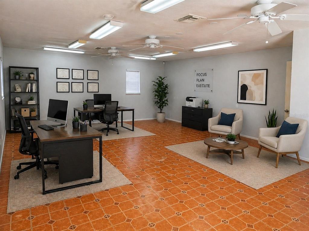 An office space features two desks, a seating area, and orange tile flooring — 167 6TH STREET SW, LARGO, FL