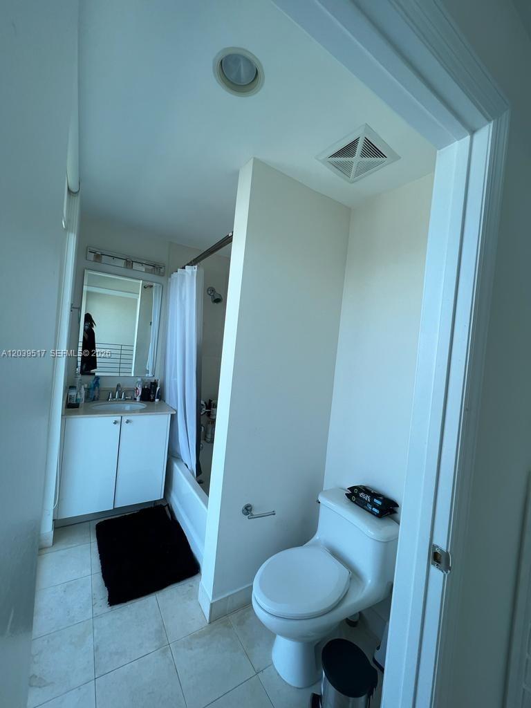 A bathroom features a white vanity, a shower-tub combination with a curtain, and a toilet — 60 SW 13th St # 2819, Miami FL 33130, MIAMI, FL