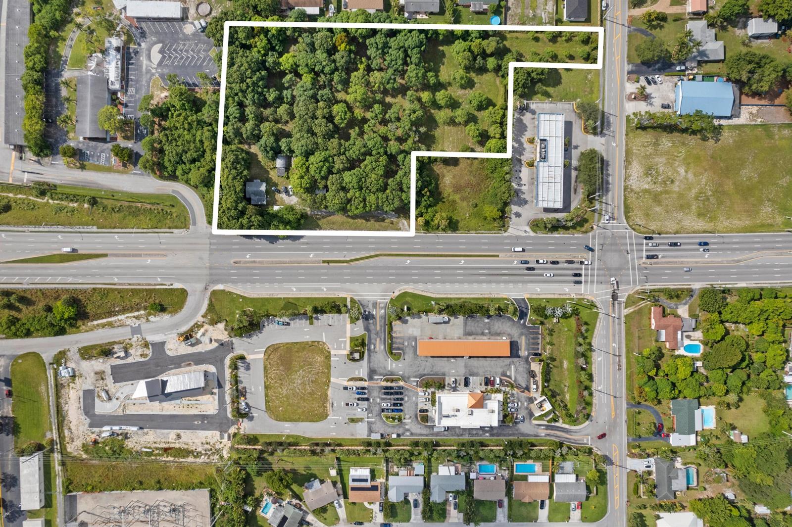 This aerial view shows a wooded lot outlined in white next to a commercial intersection — 1908 Hypoluxo Road, Lake Worth FL 33462, LAKE WORTH, FL