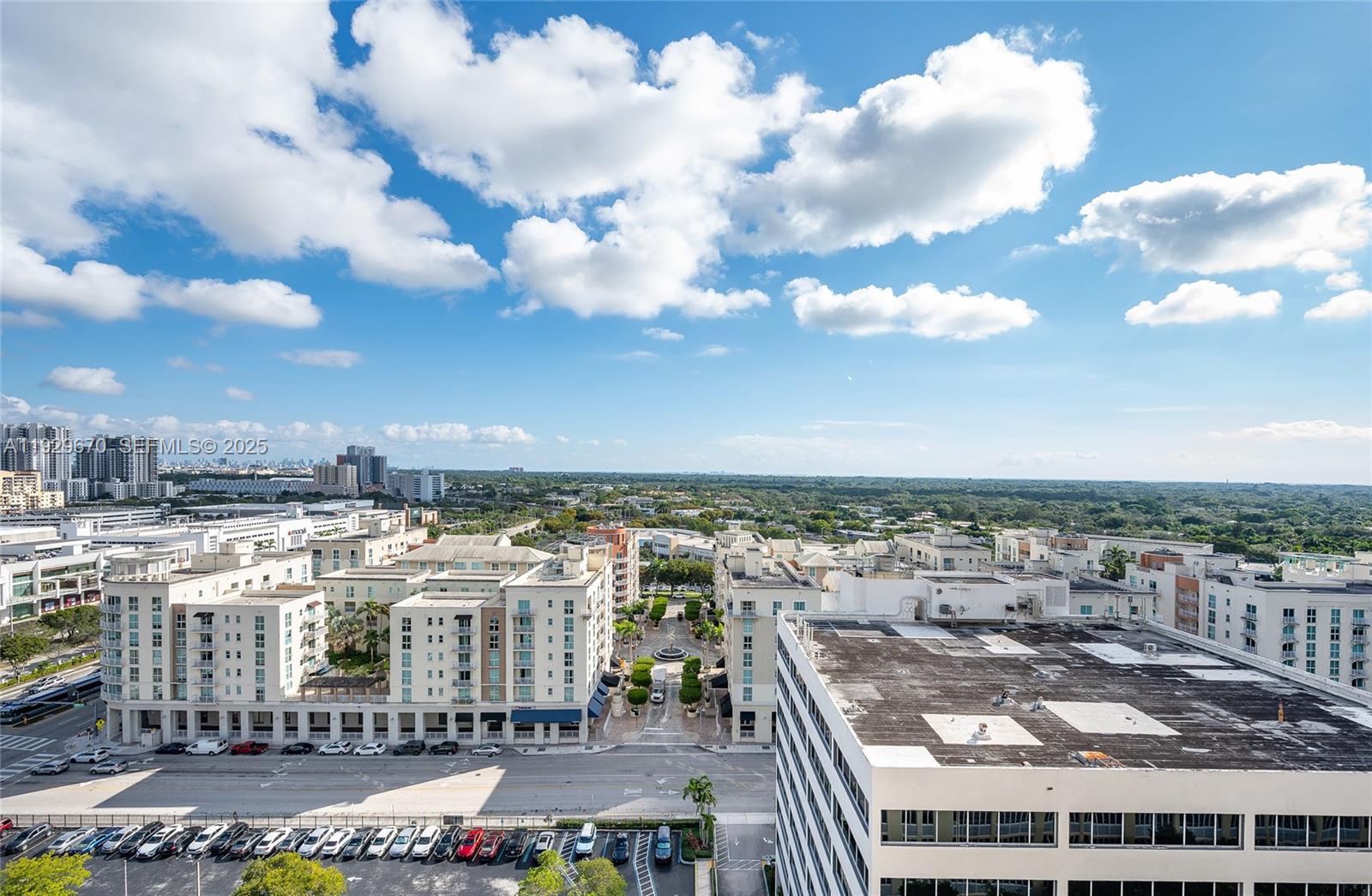 An elevated view shows a city street, apartment buildings, and a parking lot under clouds — 7350 SW 89th St # 1702S, Miami FL 33156, MIAMI, FL