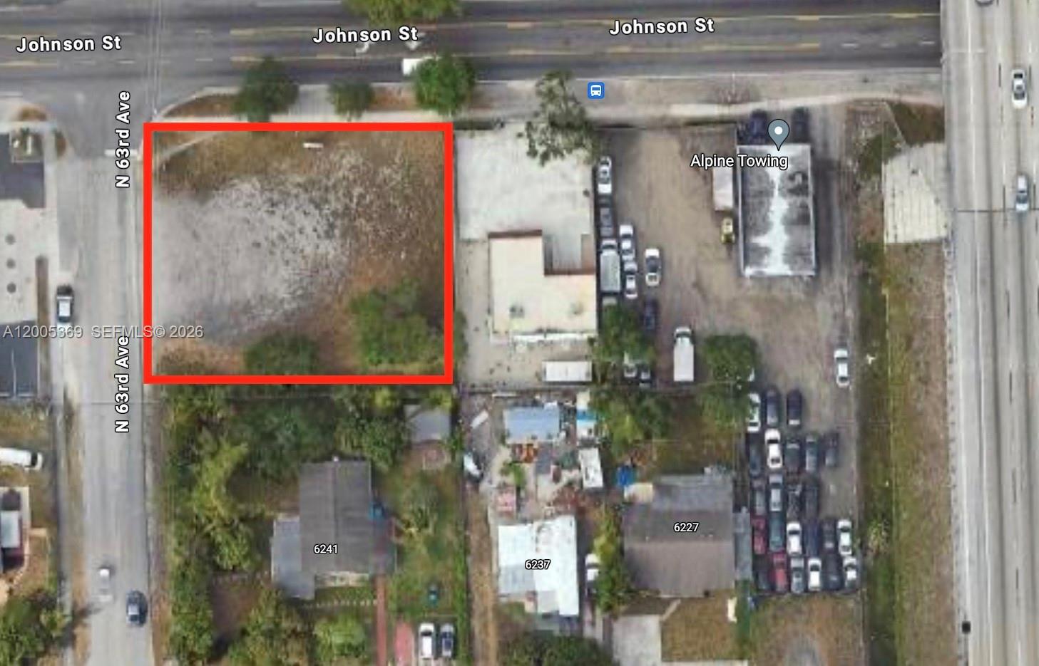 This aerial map shows a vacant rectangular lot outlined in red next to a commercial property — N 63rd Ave, Hollywood FL 33024, HOLLYWOOD, FL