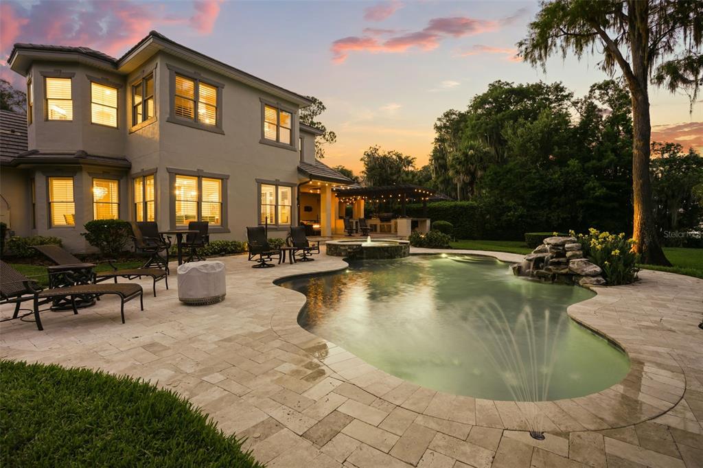 An aerial view of a boat dock on a lake with a house in the background — 5115 CRANES POINT COURT, ORLANDO, FL