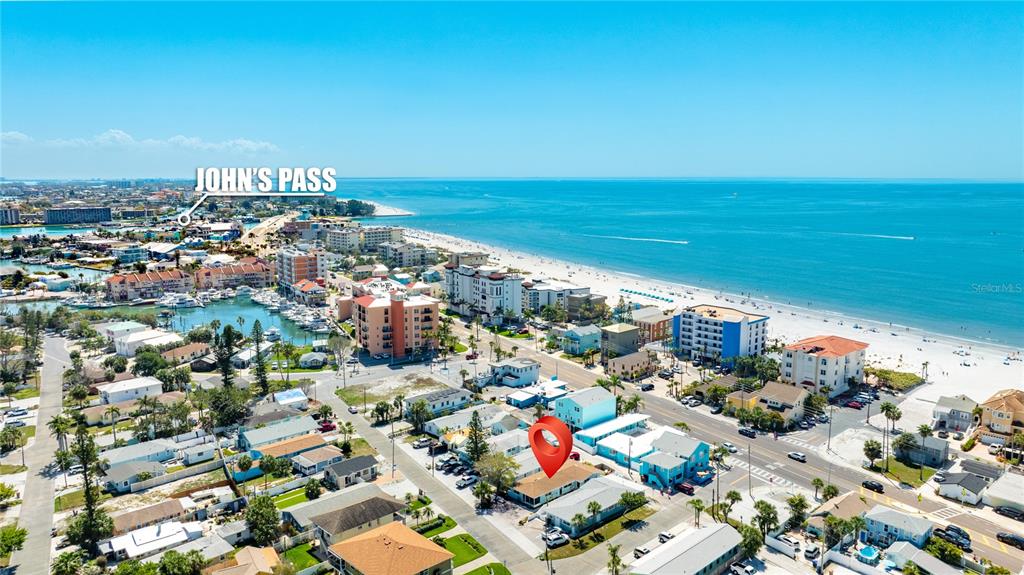 This is an aerial view of a coastal neighborhood with a red location marker — 13388 1ST STREET E, MADEIRA BEACH, FL