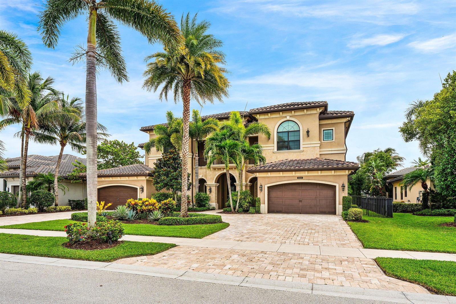 A two-story stucco house with a tile roof, palm trees, and a paved driveway — 9616 Moritz Way, Delray Beach FL 33446, DELRAY BEACH, FL