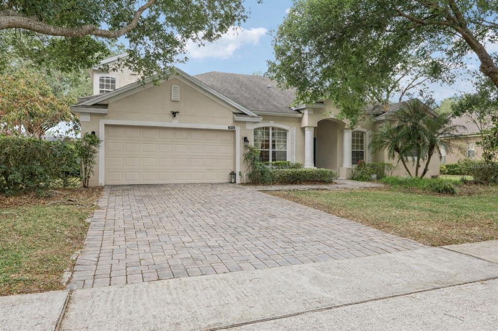 A single-story house with a paved driveway, a two-car garage, and a covered entryway — 3848 LONG BRANCH LANE, APOPKA, FL