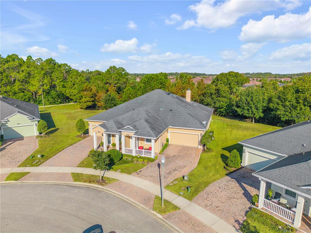A single-story house with a tan exterior, a paved driveway, and a front porch — 3367 TORRE BOULEVARD, NEW SMYRNA BEACH, FL
